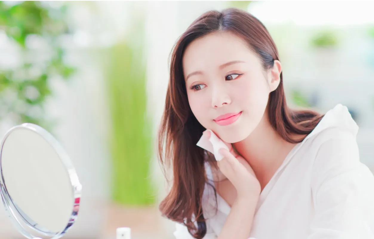 Woman Hydrating face with Hyaluronic Acid Serum
