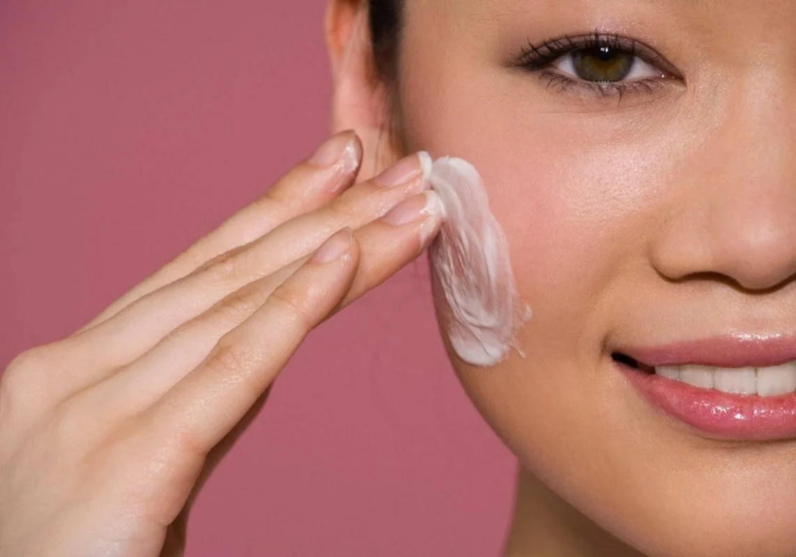 Female applying Skincare Face Cream