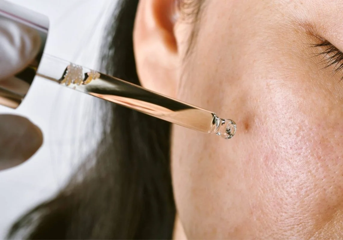 Model applying serum on a pimple